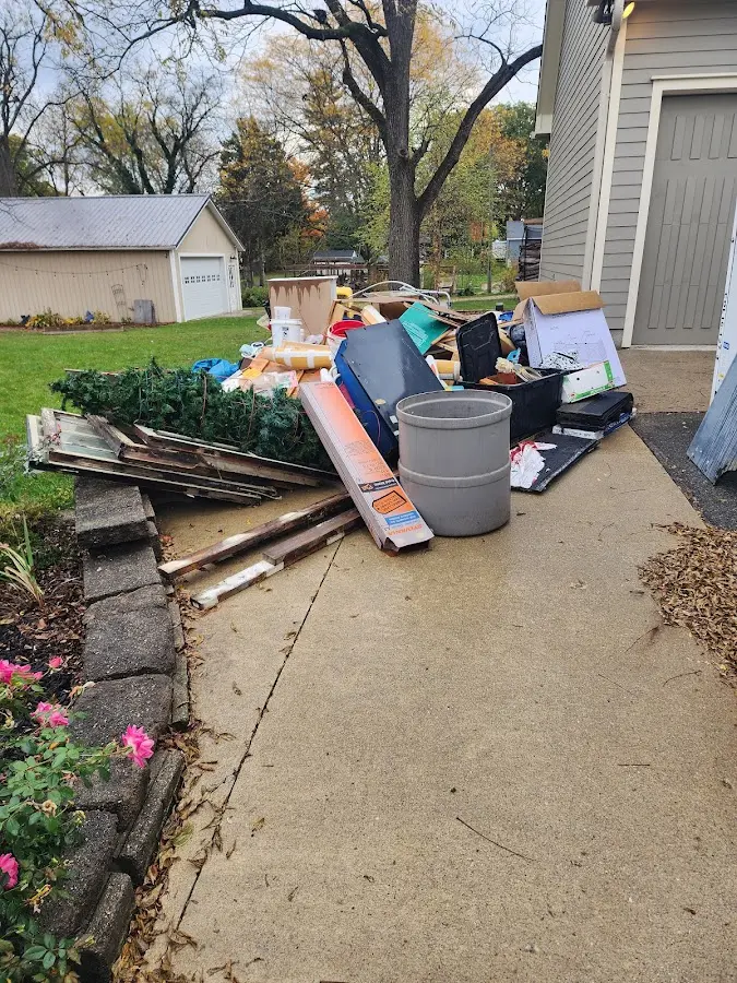Dumpster being loaded with debris for 12 Yard Dumpster Rental in Edgefield